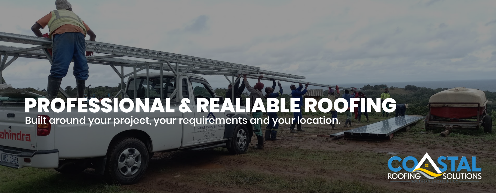 Coastal Roofing Solutions team installing steel roof trusses using a branded work vehicle at a construction site in Port Edward, KwaZulu-Natal.